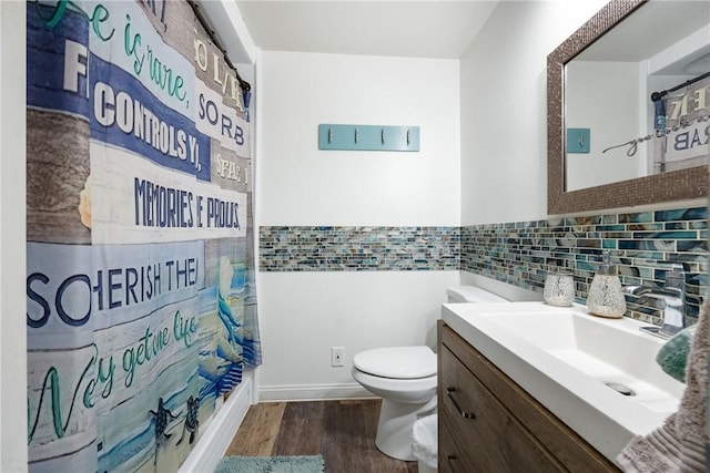 bathroom with vanity, curtained shower, wood finished floors, and toilet