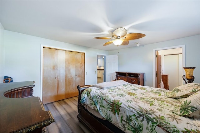 bedroom featuring ceiling fan, a closet, and wood finished floors