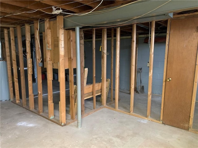 unfinished basement featuring water heater