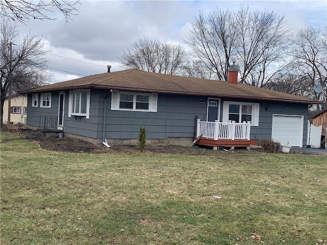 view of front of house featuring a garage, a chimney, and a front yard