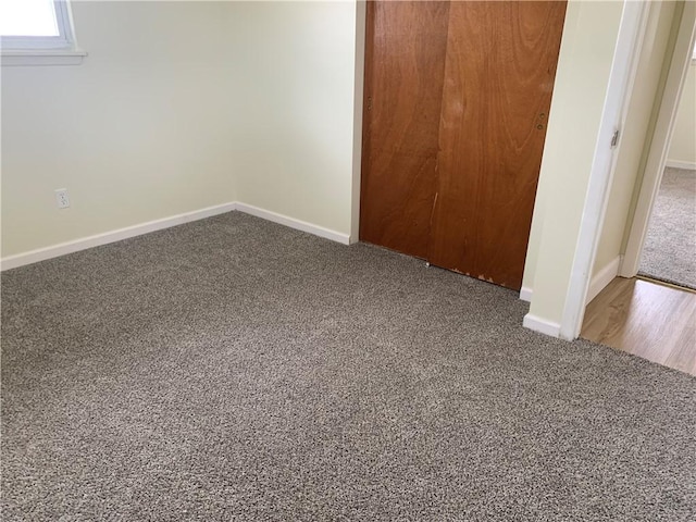 unfurnished bedroom with a closet, baseboards, and carpet flooring