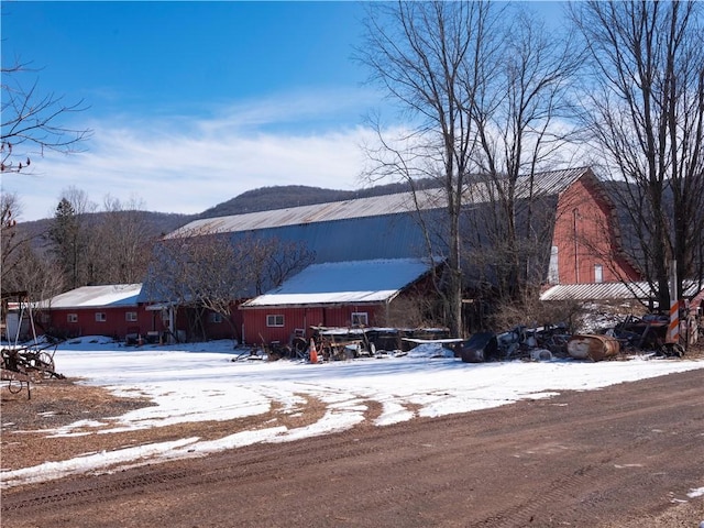 view of front of home with a barn and an outbuilding