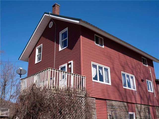 view of side of property featuring a chimney