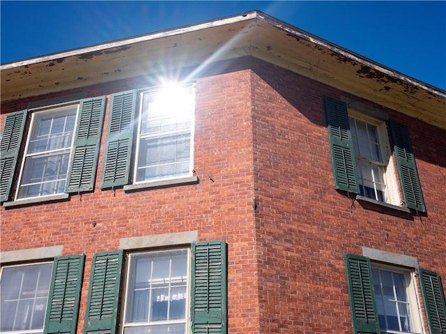 view of side of home featuring brick siding