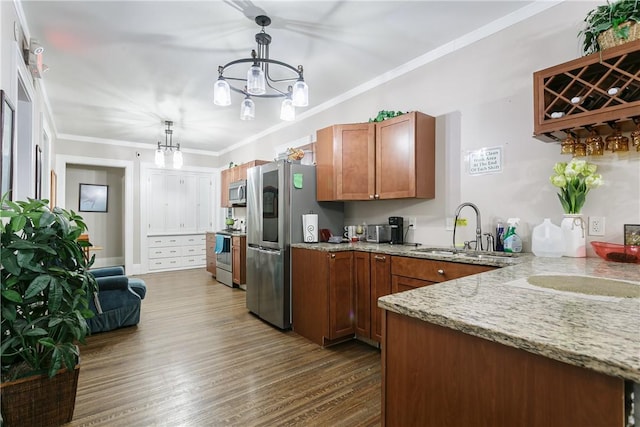 2956 Saint Paul Blvd, Irondequoit, NY 14617 - kitchen featuring a notable chandelier, crown molding, stainless steel appliances, brown cabinetry, and a sink
