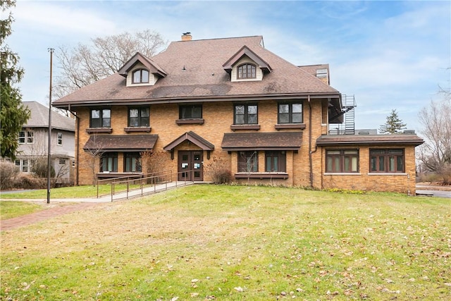 view of front of property with a chimney and a front lawn