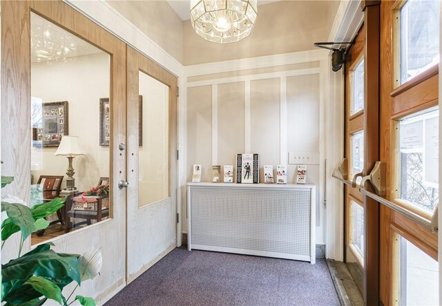 2956 Saint Paul Blvd, Irondequoit, NY 14617 - interior space with radiator heating unit, a notable chandelier, and french doors
