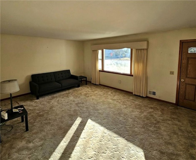 living room featuring carpet, visible vents, and baseboards