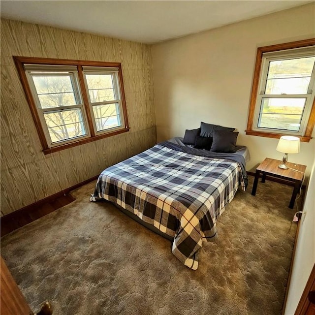 bedroom with carpet flooring and baseboards