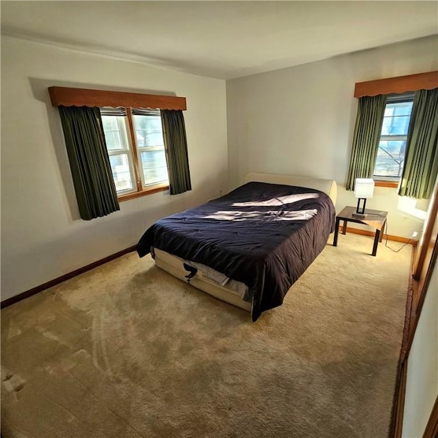 carpeted bedroom featuring baseboards