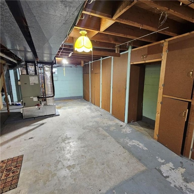 unfinished basement featuring heating unit