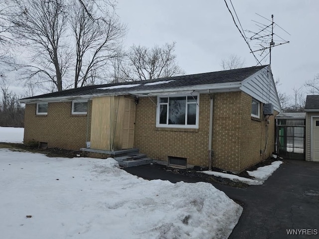 view of front of property featuring a garage and brick siding