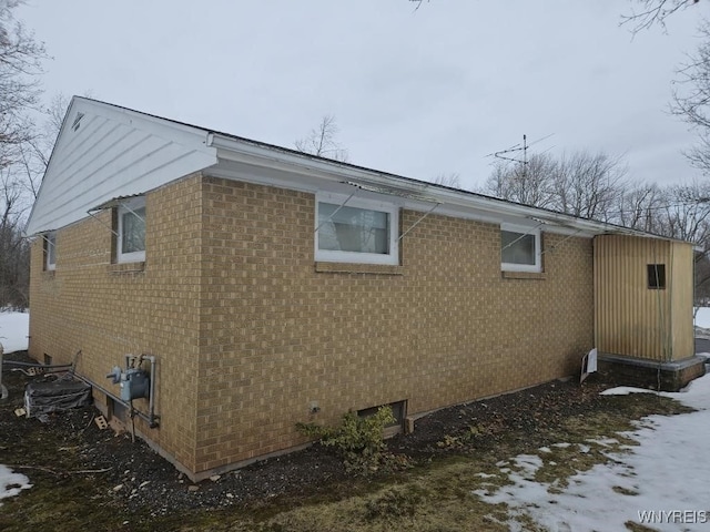 view of side of property featuring brick siding