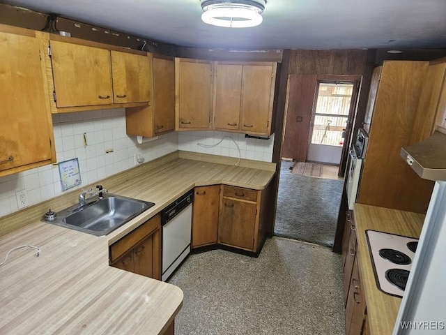 kitchen featuring white appliances, light countertops, a sink, and decorative backsplash