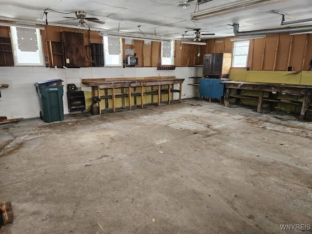 garage with ceiling fan and a workshop area