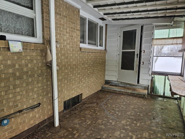 entrance to property with brick siding