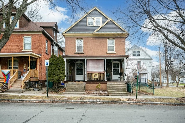 american foursquare style home with a porch