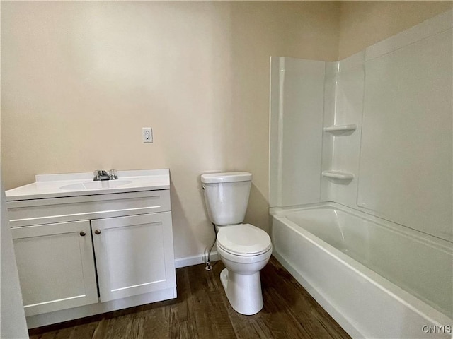 bathroom with baseboards, vanity, toilet, and wood finished floors