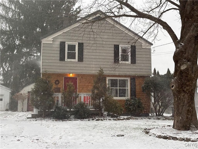 colonial house with a garage and brick siding