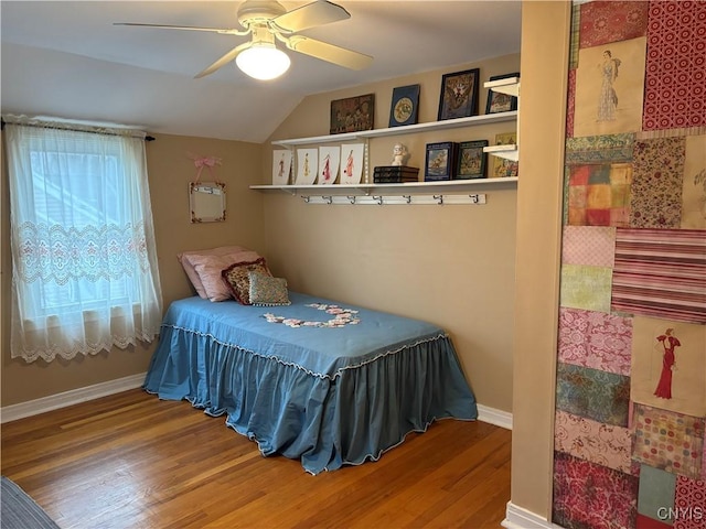 bedroom featuring lofted ceiling, ceiling fan, baseboards, and wood finished floors