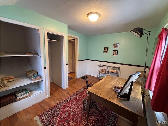 office space with baseboards and wood finished floors