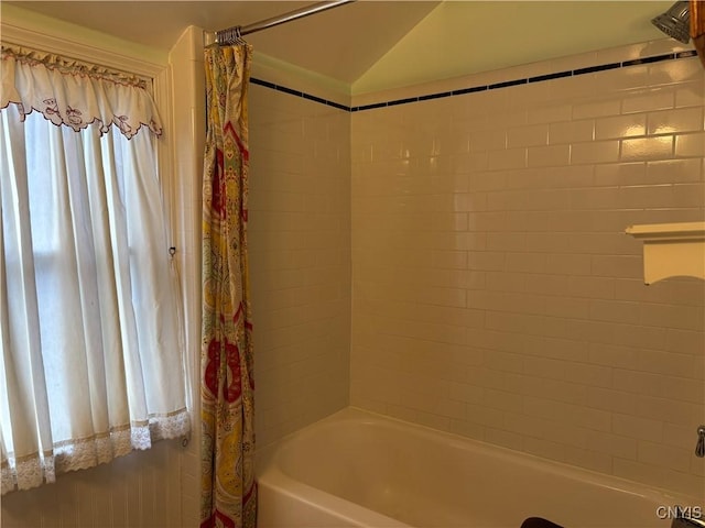 full bath featuring vaulted ceiling and shower / bathtub combination with curtain