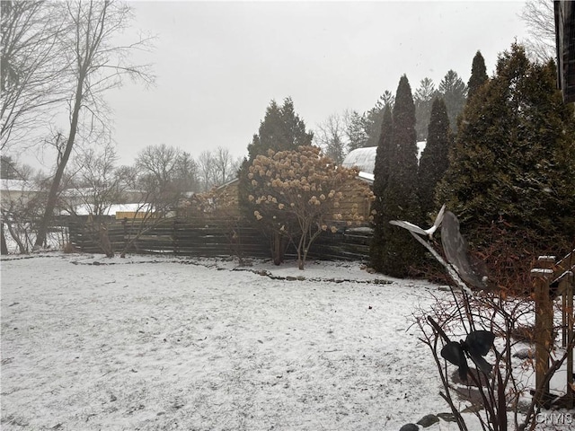 yard layered in snow with fence