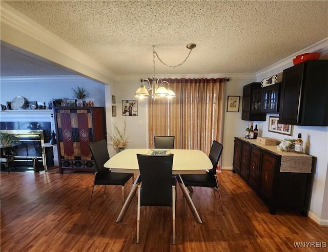 dining space with a chandelier, wood finished floors, and crown molding