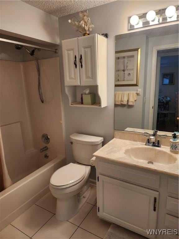 bathroom featuring a textured ceiling, vanity, tile patterned flooring, and toilet