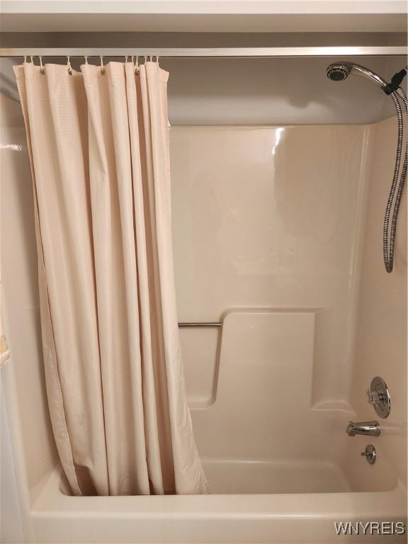 bathroom featuring shower / tub combo with curtain