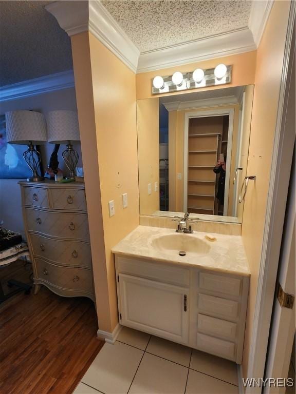 bathroom featuring ornamental molding, vanity, and tile patterned floors