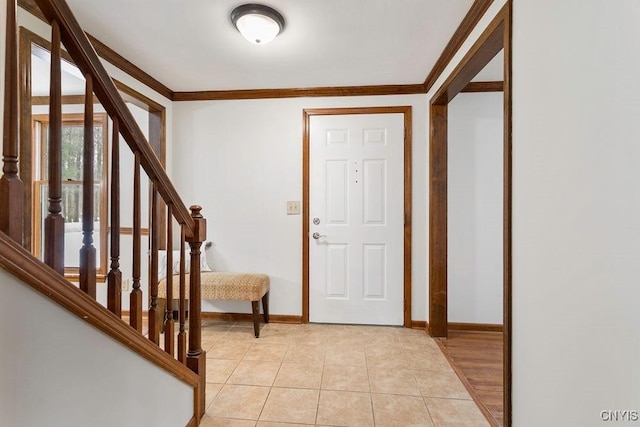 entrance foyer with stairs, ornamental molding, light tile patterned flooring, and baseboards