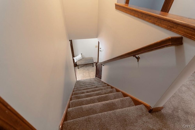 stairway with carpet floors and baseboards