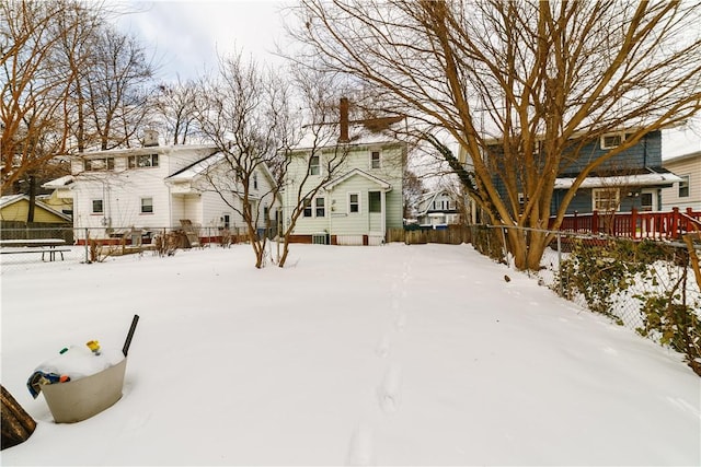 yard covered in snow with fence and a residential view