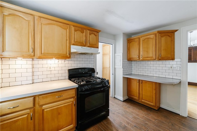 kitchen with dark wood-style floors, light countertops, black gas range, and under cabinet range hood