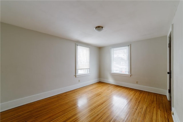 empty room with light wood-style floors and baseboards