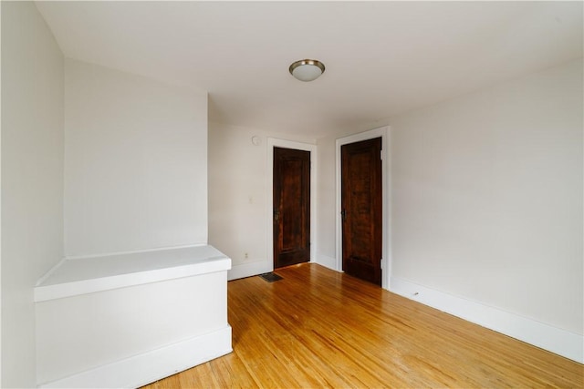 spare room with light wood finished floors and baseboards