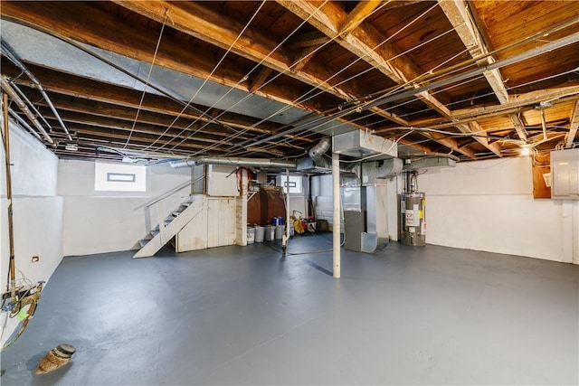 basement with heating unit, stairs, electric panel, and gas water heater