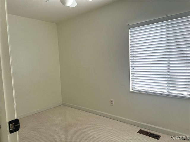 spare room featuring visible vents, ceiling fan, baseboards, and carpet