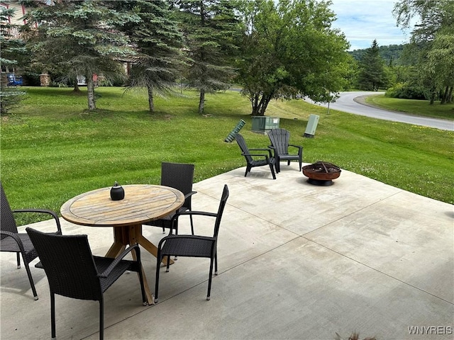 view of patio / terrace with outdoor dining area and an outdoor fire pit