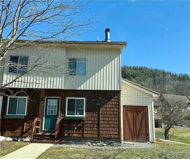 rear view of property featuring a garage