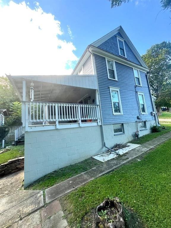 view of side of property with a lawn