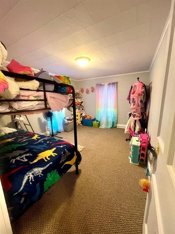 carpeted bedroom featuring ornamental molding