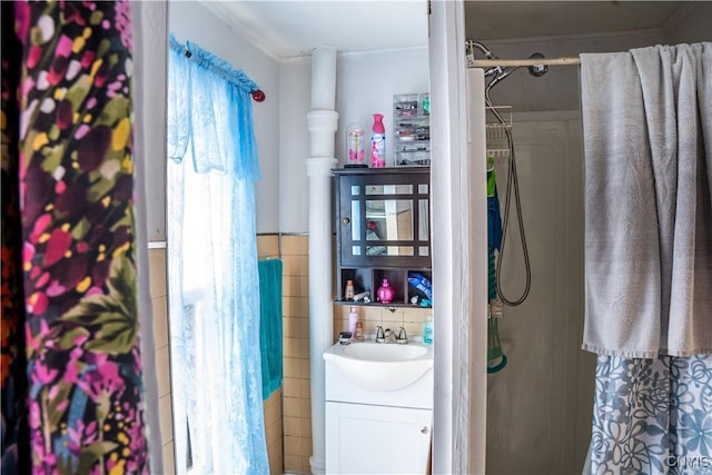 full bathroom featuring tile walls and vanity