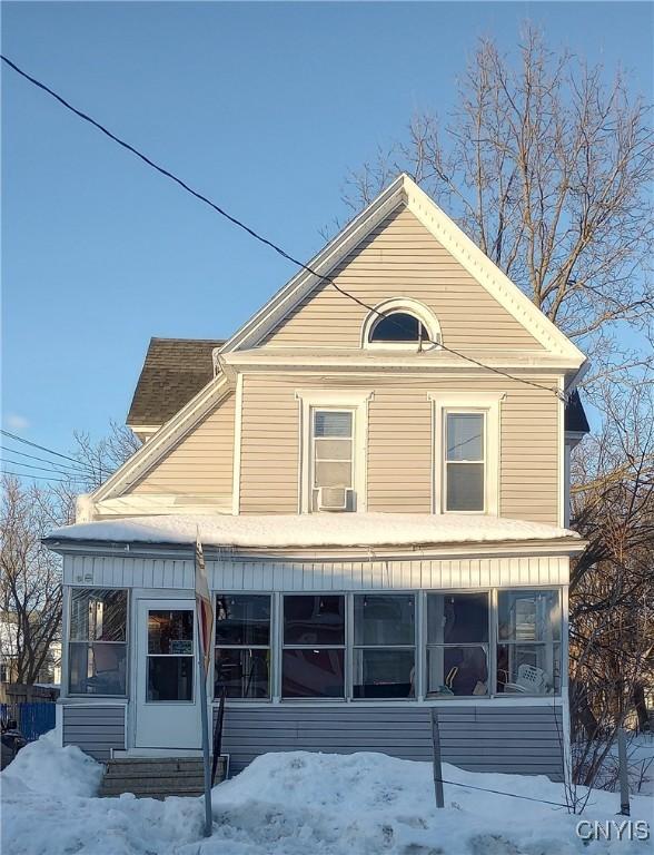 exterior space with entry steps, a sunroom, and cooling unit