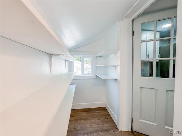 spacious closet featuring vaulted ceiling and dark wood finished floors