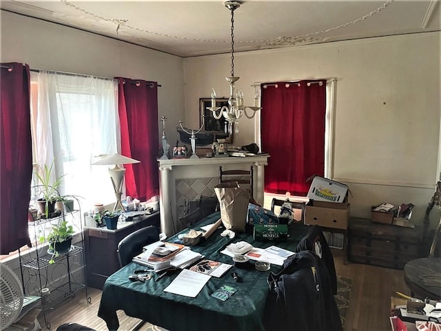 dining area with a notable chandelier and wood finished floors