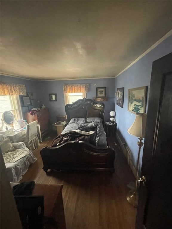 bedroom featuring ornamental molding and wood finished floors