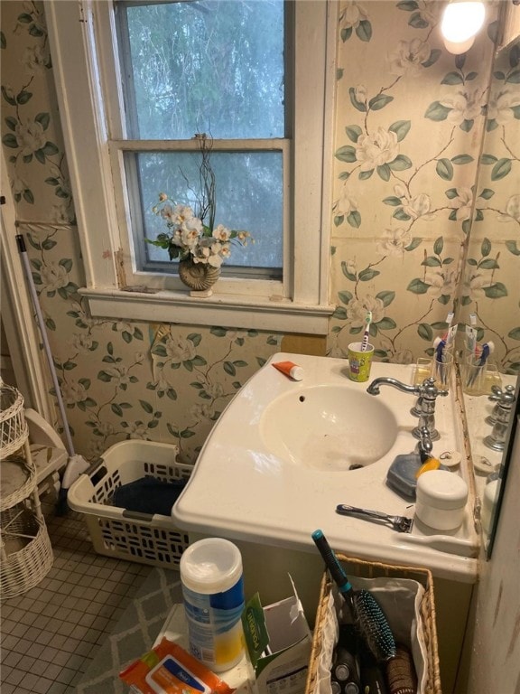 bathroom featuring vanity and wallpapered walls