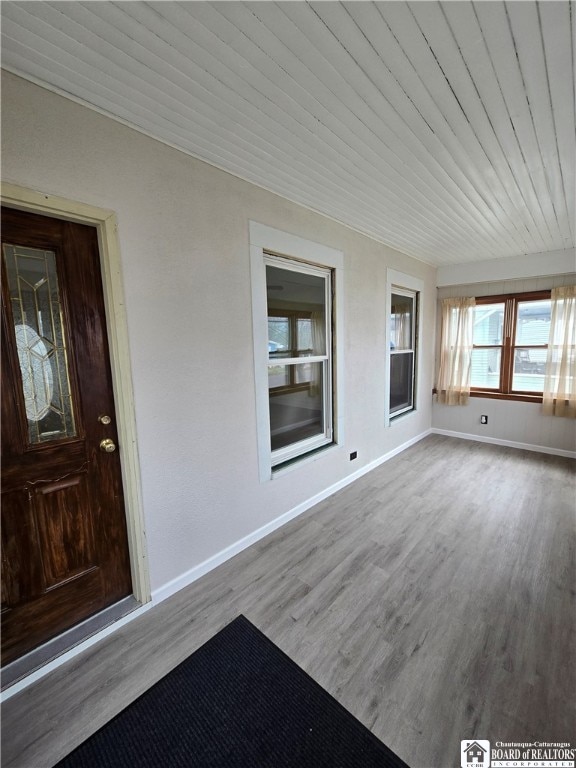 unfurnished sunroom with wooden ceiling